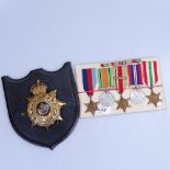 5 Second World War medals with ribbons, and a Oxfordshire Infantry badge mounted on a shield