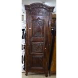 An Antique Continental fruitwood arch-top hall cupboard, with a 3 fielded panelled and carved