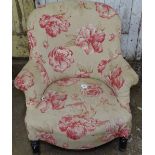 An Edwardian upholstered low armchair