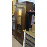 An Art Nouveau oak single mirror door wardrobe, with stylised inlaid decoration, W90cm