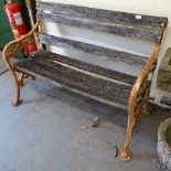 A scrolled cast-iron and slatted garden bench, W117cm