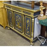An ornate gilded side cabinet with 3 panelled doors, split turned fluted columns, on bun feet,