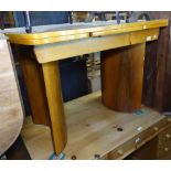 An Art Deco walnut bow-end draw leaf dining table, W106cm