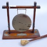 An Arts and Crafts oak gong with metal mounts, and striker, height 10.25"
