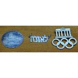 A 1936 Berlin Olympic enamel badge, a 1972 Munich Olympic coin, and a Jewish pendant