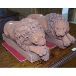 A pair of terracotta recumbent lions, 43cm
