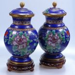 A pair of cloisonne jars and covers, height 11.75", with carved wood stands