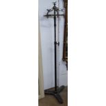 An unusual Continental cast-iron and brass telescopic hat/coat stand, surmounted by birds, the