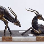 A Continental marble stand surmounted by patinated spelter antelope, length 21"