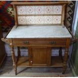 An Edwardian walnut marble and tiled-back washstand, W110cm