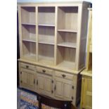 A modern limed-oak effect 2-section display cabinet, base fitted with drawers and cupboards, on