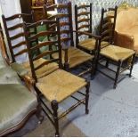 A set of 5 1920s oak ladder back dining chairs, with rush seats, comprising 4 standard and 1 elbow