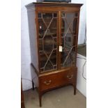 A late 19th century mahogany cabinet on stand, with 2 lattice-glazed doors and fitted drawer to