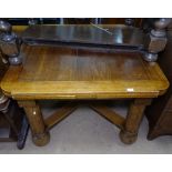 An Art Deco oak draw leaf dining table, with cross stretcher and turned legs, W105cm