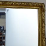 An Antique wall mirror in embossed foliate design frame, height 21"