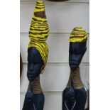 A pair of African carved ebony and beadwork figures