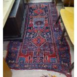 A red ground Beluchi rug, 230cm x 110cm