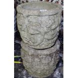 A pair of weathered textured concrete garden planters