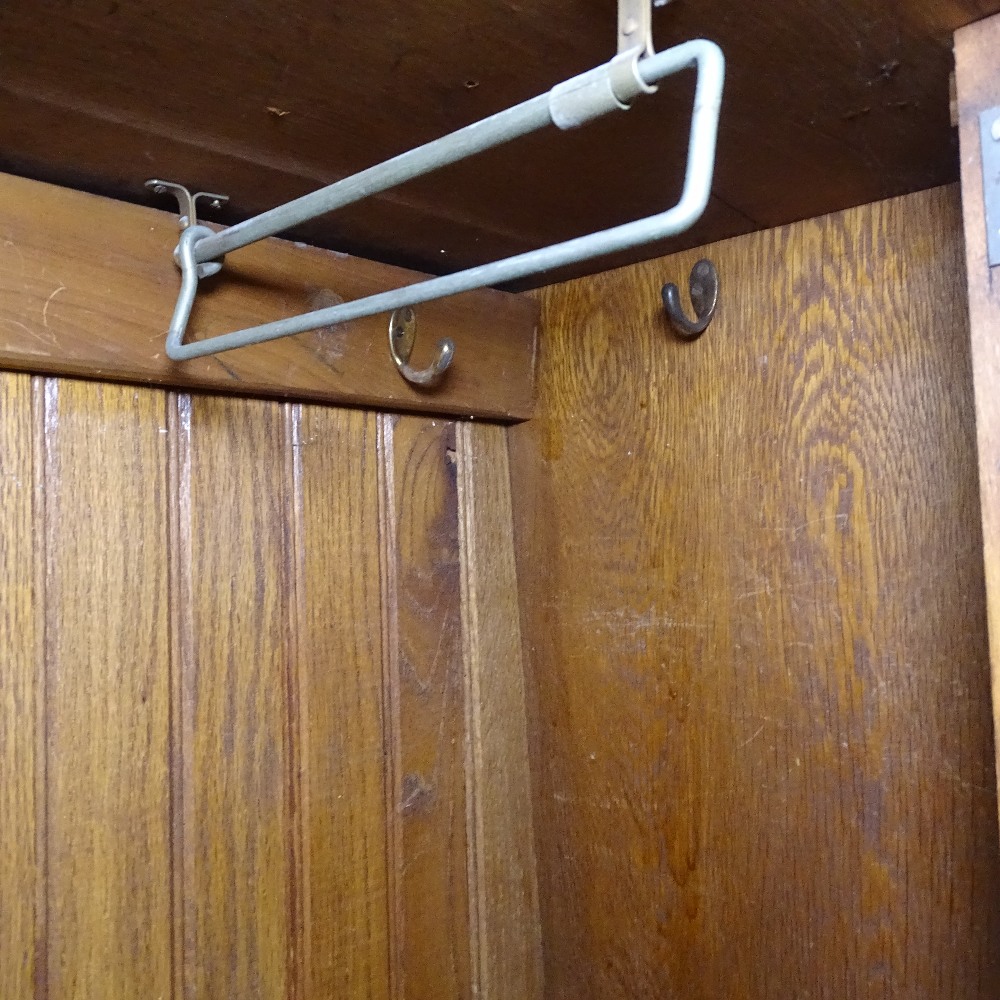 A stylised Art Nouveau oak hall cupboard, with single panel door and copper panels, on bracket feet, - Image 2 of 2