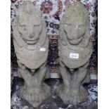 A pair of weathered concrete garden rampant lions, H54cm