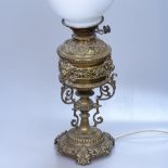 Antique embossed and pierced brass oil lamp converted to electricity, 22.75" overall