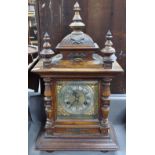 A carved oak-cased 2-train mantel clock, 18"