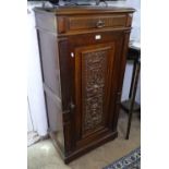 An Antique Continental oak side cabinet, with single frieze drawer, and carved panelled cupboard