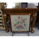 An oak-framed firescreen, and a fold over table on cabriole legs