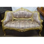 A Continental giltwood and upholstered salon settee, on scrolled legs, L132cm