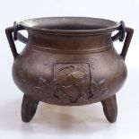 An Oriental bronze cauldron with swing handle, height 7.25"