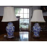 A pair of blue and white glazed ceramic baluster table lamps and shades, height including shade 62cm