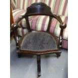 A 1920s swivel desk chair