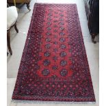 A red ground wool Turkish runner, 230cm x 80cm