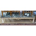 An Italian marble-top coffee table, of rectangular form, with carved painted and giltwood frieze,