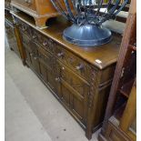 A 1920s carved oak sideboard, with 3 frieze drawers, panelled cupboards under, stile legs, L183cm,