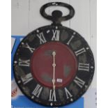 A large painted metal clock, W63cm