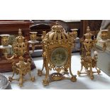 An ornate 19th century gilt-bronze cased 3-piece clock garniture, with engraved brass dial and 8-day