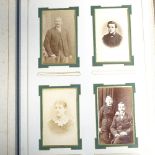 An old family photo album with 18 cabinet photos and 64 carte de visite, together with a postcard