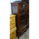 A hardwood arch-top display cabinet, with single glazed door, and drawers to the base, W75cm, H175cm