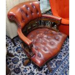 A reproduction brown studded leather upholstered swivel desk chair