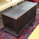 An Antique panelled oak coffer, W110cm