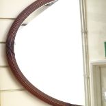 A mahogany oval mirror with reeded and carved ribbon-tied frame, width 38"