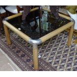 A 1960s Rodney Kinsman teak coffee table with smoked glass top and cast metal corners, W84cm