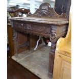 A Victorian carved oak side table with raised back, and lion mask frieze drawer, W91cm