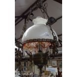 A brass and glass hanging oil lamp, converted to electricity, height 24" approx