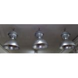 A set of 3 industrial metal light fittings.