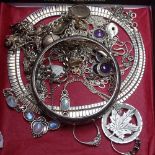 A tray containing silver and moonstone necklace, a silver bangle, and other silver jewellery