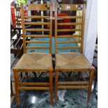 A pair of oak Arts and Crafts ladder-back side chairs, with rush seats