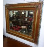 A cushion-framed oak and gilded bevelled-edge wall mirror, W110cm, H94cm