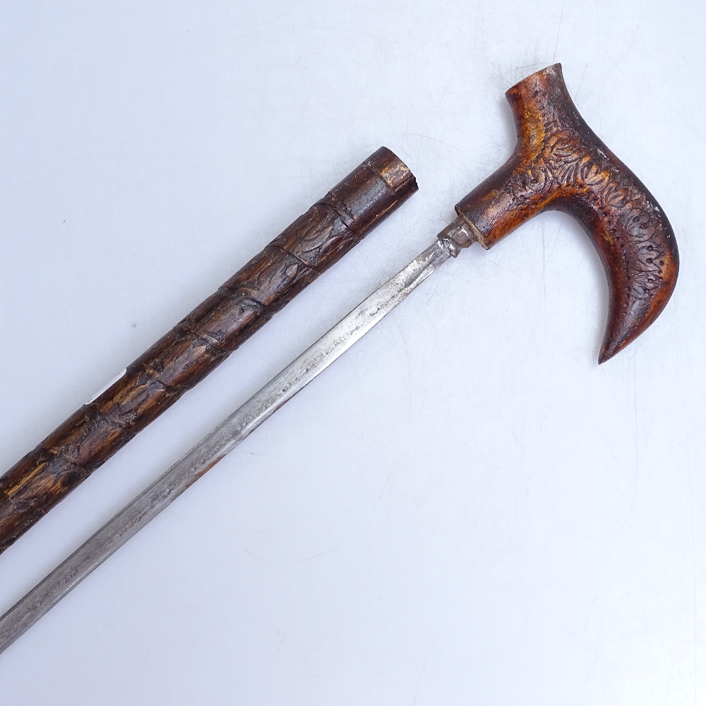 A carved wood sword stick, length 19"